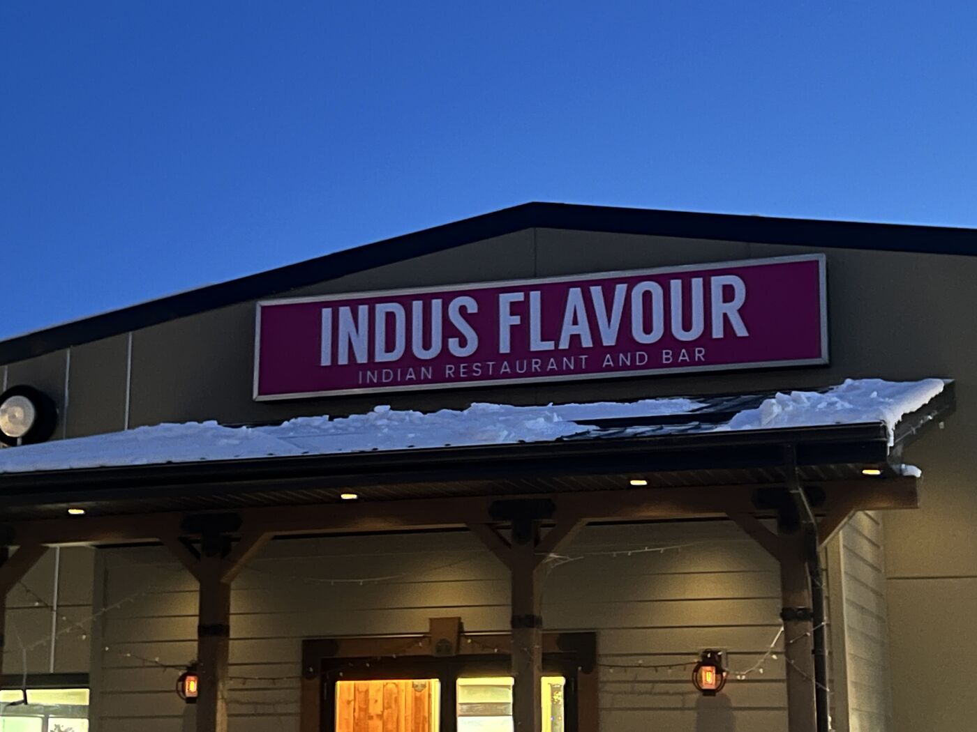 Restaurant storefront fascia sign at dusk — Action Signs & Graphics